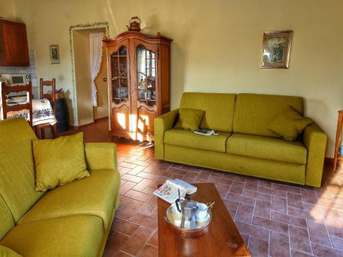 a living room with two couches and a coffee table at Pretty farmhouse with terrace in Radda in Chianti