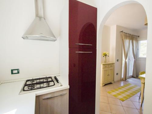 a kitchen with a sink and a stove top oven at elegant apartment near the beach of Baja Sardinia in Baraccamenti