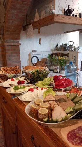 a buffet with many different types of food on a counter at Żabie Oko in Kruklanki