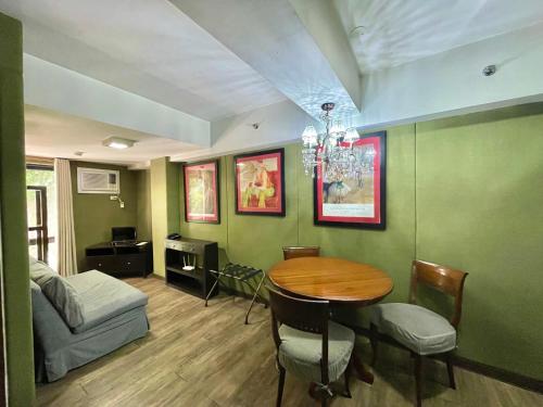 a living room with a table and a bed at CEO Flats in Manila
