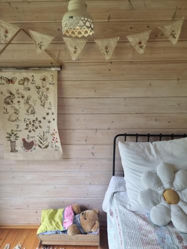 a bedroom with a wooden wall and a bed with a stuffed animal at Countryhouse Lake Attersee - Traumhaft schöne Lage - Bezauberndes Hideaway in Unterach am Attersee