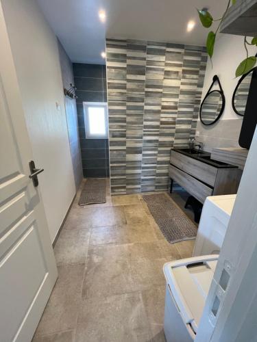 a bathroom with a sink and a vanity and a sink at Arlega in Saint-Germain-sur-Ay