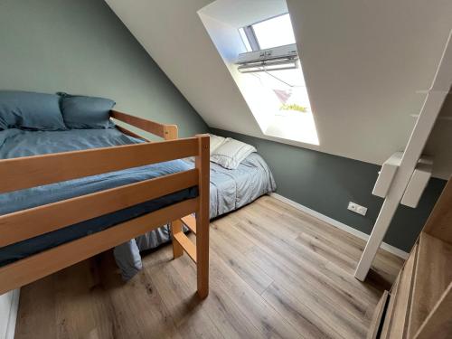 a attic room with a bunk bed and a small bedroom at Arlega in Saint-Germain-sur-Ay