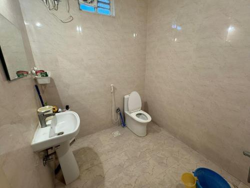 a bathroom with a sink and a toilet at FF Family Farm in Hyderabad