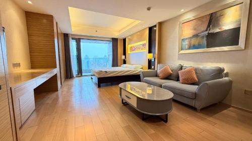 a living room with a couch and a table at Beijing Sanlitun Shimao International Serviced Apartments in Beijing