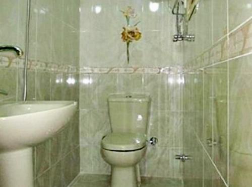 a bathroom with a toilet and a sink at Magic golden pyramids view in Cairo