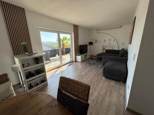 a living room with a couch and a table at Einmaliger Ausblick und tolles Ambiente in Laubenheim