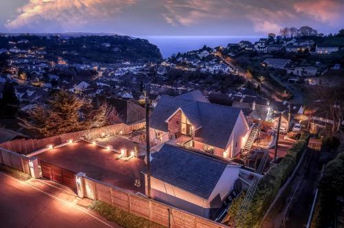an aerial view of a house at night at Sea Holly House - Where Architecture Meets the Ocean in Beer