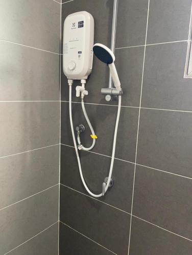 a shower in a bathroom with a hair dryer at Dream Home Landed Balik Pulau in Balik Pulau