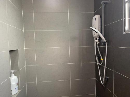 a shower with a hand dryer in a bathroom at Dream Home Landed Balik Pulau in Balik Pulau