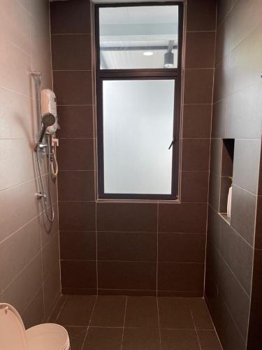 a bathroom with a shower with a window and a toilet at Dream Home Landed Balik Pulau in Balik Pulau