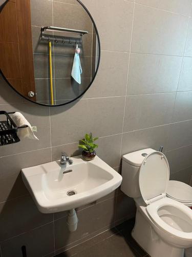 a bathroom with a sink and a toilet and a mirror at Dream Home Landed Balik Pulau in Balik Pulau