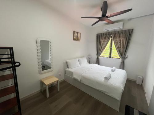 a bedroom with a bed and a ceiling fan at Alur Homestay Casa 4 Bedrooms in Lahad Datu