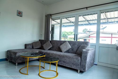 a living room with a couch and two tables at Relax home in Ao Nang 
