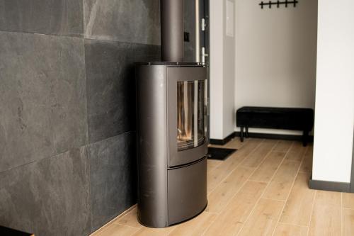 a metal fireplace in a room with a wooden floor at domki Koziniec na wyłączność Myczkowce Solina Bieszczady 5 in Myczkowce