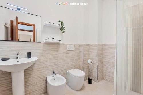 a bathroom with a sink and a toilet and a mirror at Il Paguro, Terre Marine in Lerici