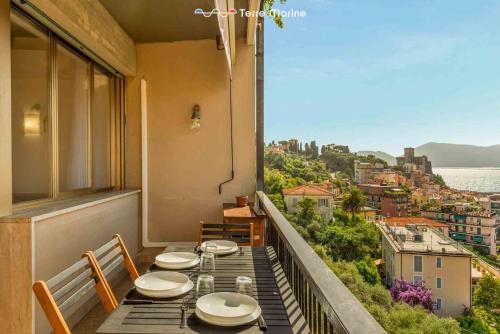 a balcony with two tables and a view of the city at Il Paguro, Terre Marine in Lerici