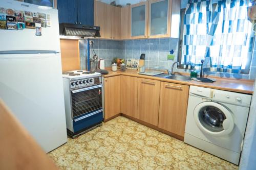 a kitchen with a refrigerator and a washing machine at Serene housecomplex,110m2 house by marvellous sea in Mola Kalyva
