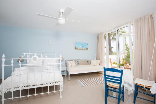 a white bedroom with a bed and a couch at Villa Lena in Stelida