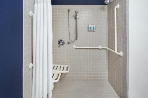 a shower with a white shower curtain in a bathroom at Residence Inn by Marriott Miami Airport in Miami