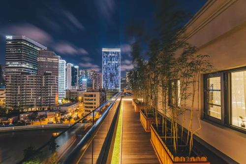 a view of a city skyline at night at Atour Light Hotel Shanghai Jing'an Natural History Museum, Suzhou River Bank in Shanghai