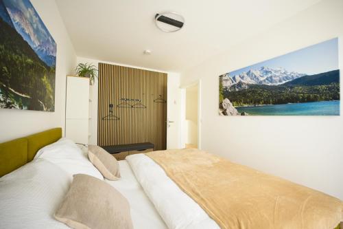a bedroom with a bed with a large picture on the wall at VARIO-HAUS Residence in Theresienfeld