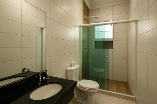 a bathroom with a sink and a toilet at Marmeu Enseada in Guarujá