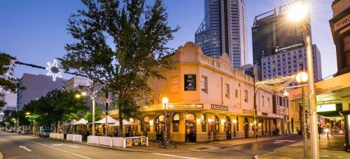 a building on a street in a city at night at Luxury Perth CBD Apartment with Pool & Gym - Sleeps 3 in Perth