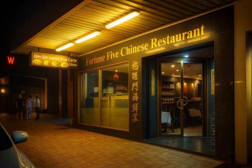a building with a sign that reads future fire chinese restaurant at Luxury Perth CBD Apartment with Pool & Gym - Sleeps 3 in Perth