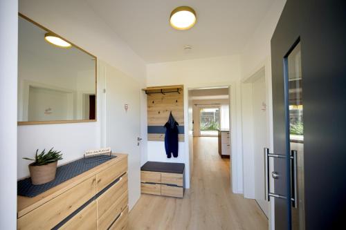 a bathroom with a sink and a mirror at VARIO-HAUS Residence in Theresienfeld