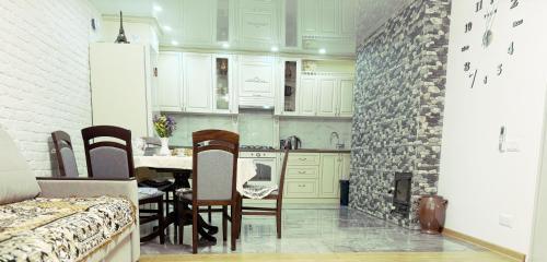 a kitchen with a table and a brick wall at Casa Veche 