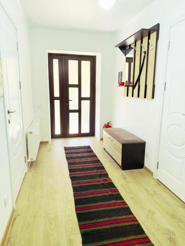 a living room with a door and a rug at Casa Veche 