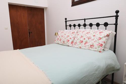 a white bed with a pillow on top of it at Pure Gardères in Monlezun