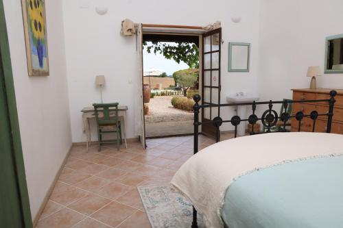 a bedroom with a bed and a view of a yard at Pure Gardères in Monlezun