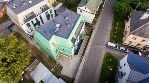 an overhead view of a large house with a blue roof at Sodų Vilos in Kaunas