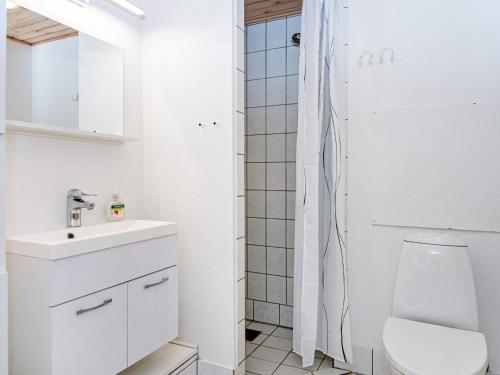 a white bathroom with a toilet and a sink at 6 person holiday home in Fanø-By Traum in Fanø