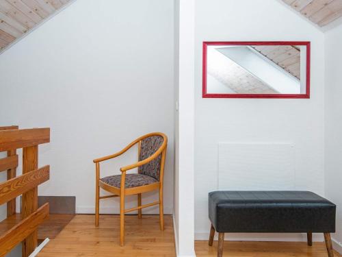 a chair and a ottoman in a room at 6 person holiday home in Fanø-By Traum in Fanø