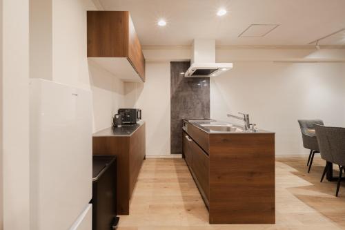 a kitchen with a sink and a counter at The LOFT INN FUKUOKA in Fukuoka