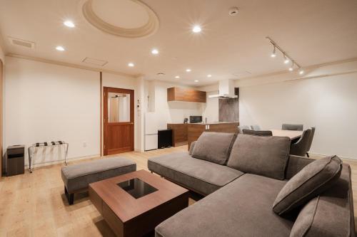 a living room with a couch and a table at The LOFT INN FUKUOKA in Fukuoka