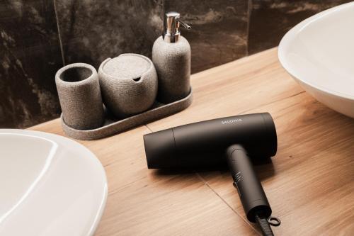 a hair dryer sitting on a table next to a sink at The LOFT INN FUKUOKA in Fukuoka