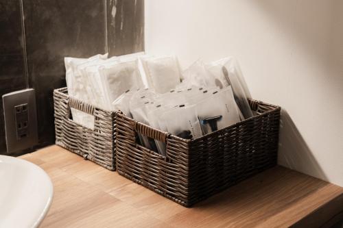 a wicker basket sitting on the floor next to a toilet at The LOFT INN FUKUOKA in Fukuoka