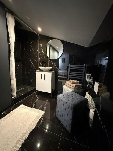 a black room with a mirror and a couch at Mondden Penthouse Apartaments in Chişinău