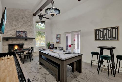 a living room with a ping pong table and a fireplace at Whitewater River House - Game Room, Firepit, Walking distance to Whitewater Amphitheater! in Sattler