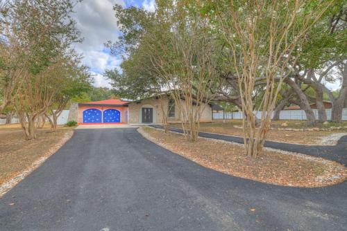 a driveway leading to a house with blue doors at Whitewater River House - Game Room, Firepit, Walking distance to Whitewater Amphitheater! in Sattler