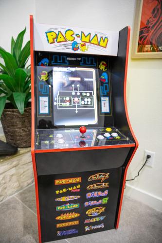 a race man arcade video game machine in a room at Whitewater River House - Game Room, Firepit, Walking distance to Whitewater Amphitheater! in Sattler