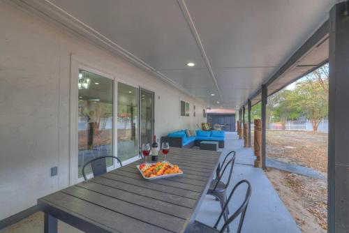 a wooden table with a plate of food on it at Whitewater River House - Game Room, Firepit, Walking distance to Whitewater Amphitheater! in Sattler