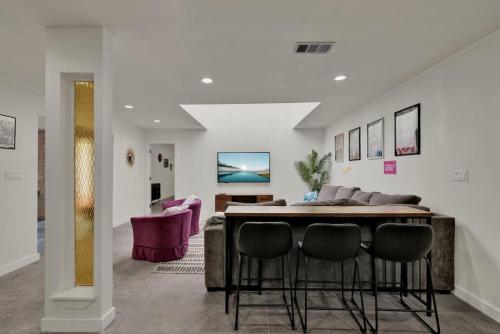 a living room with a table and some chairs at Whitewater River House - Game Room, Firepit, Walking distance to Whitewater Amphitheater! in Sattler