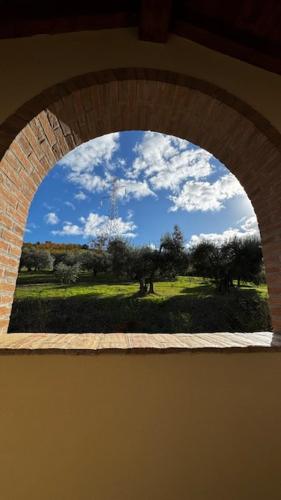 an archway with a view of a field and trees at Farm Ca Nick in Fermo