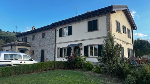 a white car parked in front of a house at Farm Ca Nick in Fermo