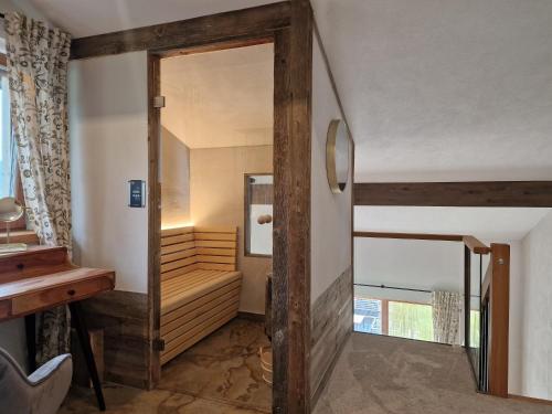 a hallway with a wooden door leading into a room at Alpenchalet Vils Tirol in Vils